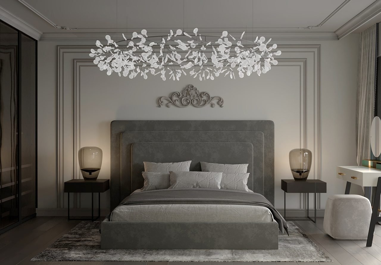Moody primary bedroom with a branch chandelier and velvet headboard